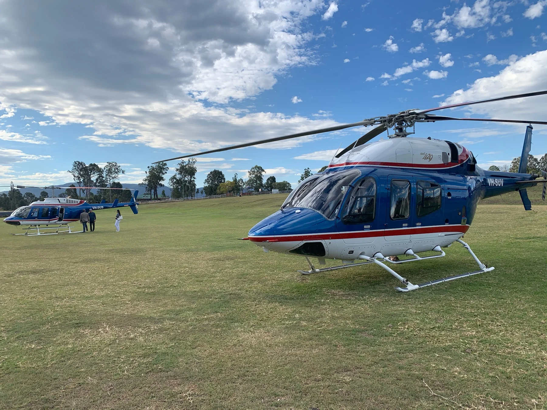 Blesk Bell 429 helicopters on the grass at an airfield