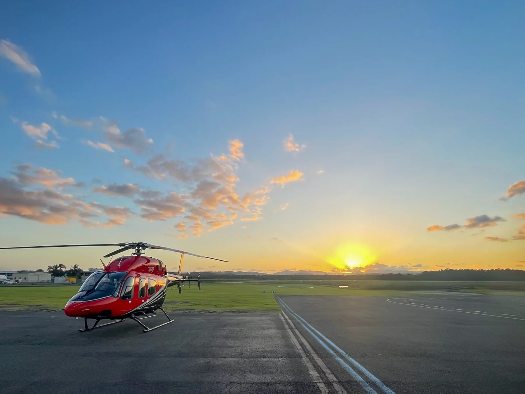 Blesk's red Bell 429 at Archerfield at sunset